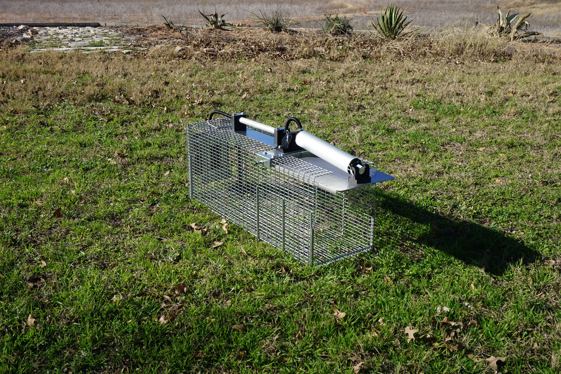 OcuTrap R1 smart cage trap deployed on grass in the field